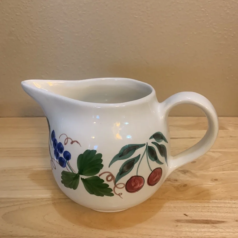 Crate & Barrel white ceramic pitcher hand painted with cherries and grapes.